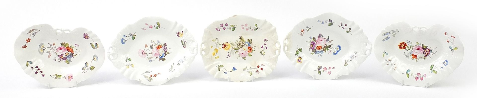 Five early 19th century porcelain dishes hand painted with flowers, the largest 27cm wide