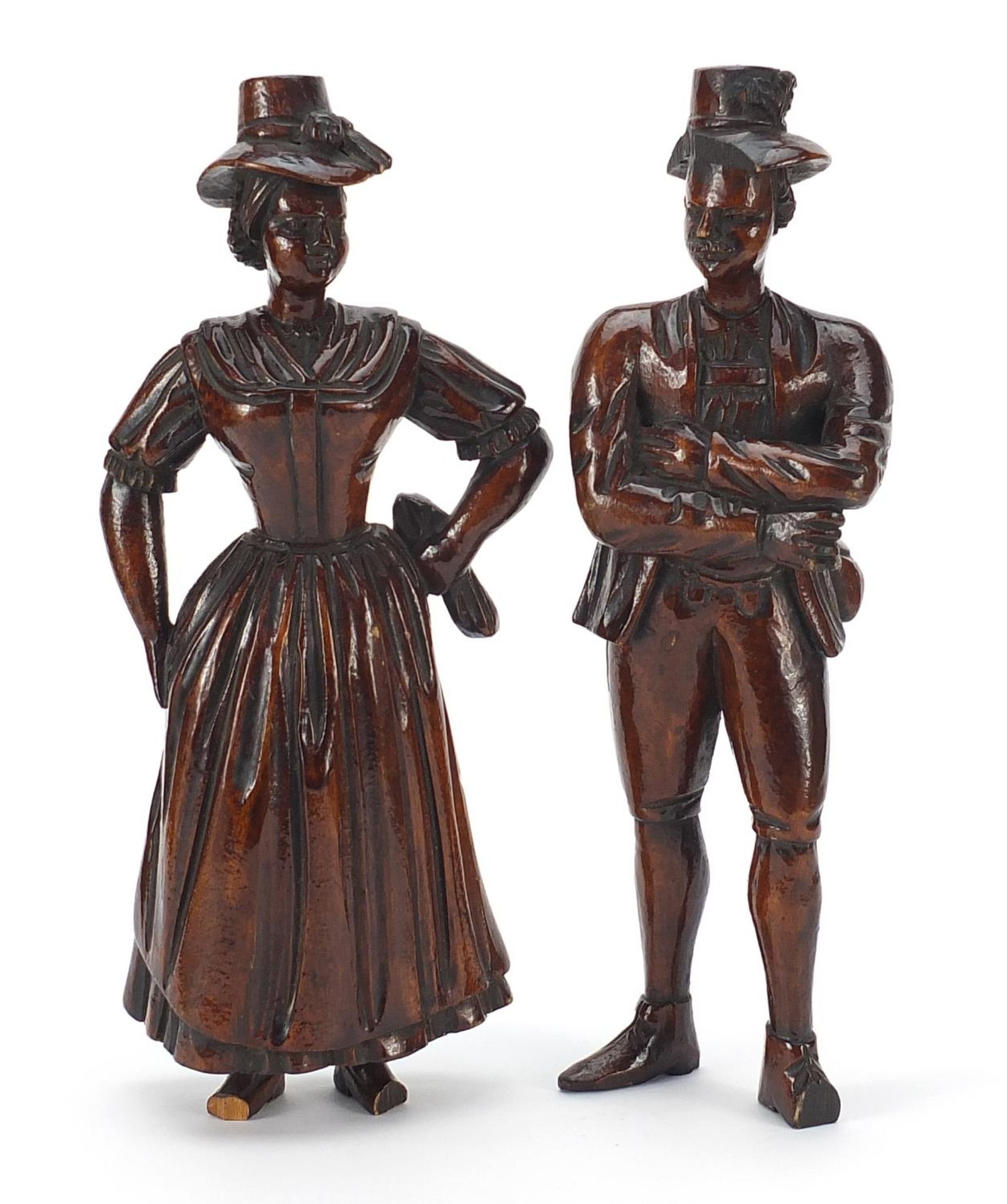 Pair of antique continental wood carvings of peasants in 18th century dress, the largest 22cm high