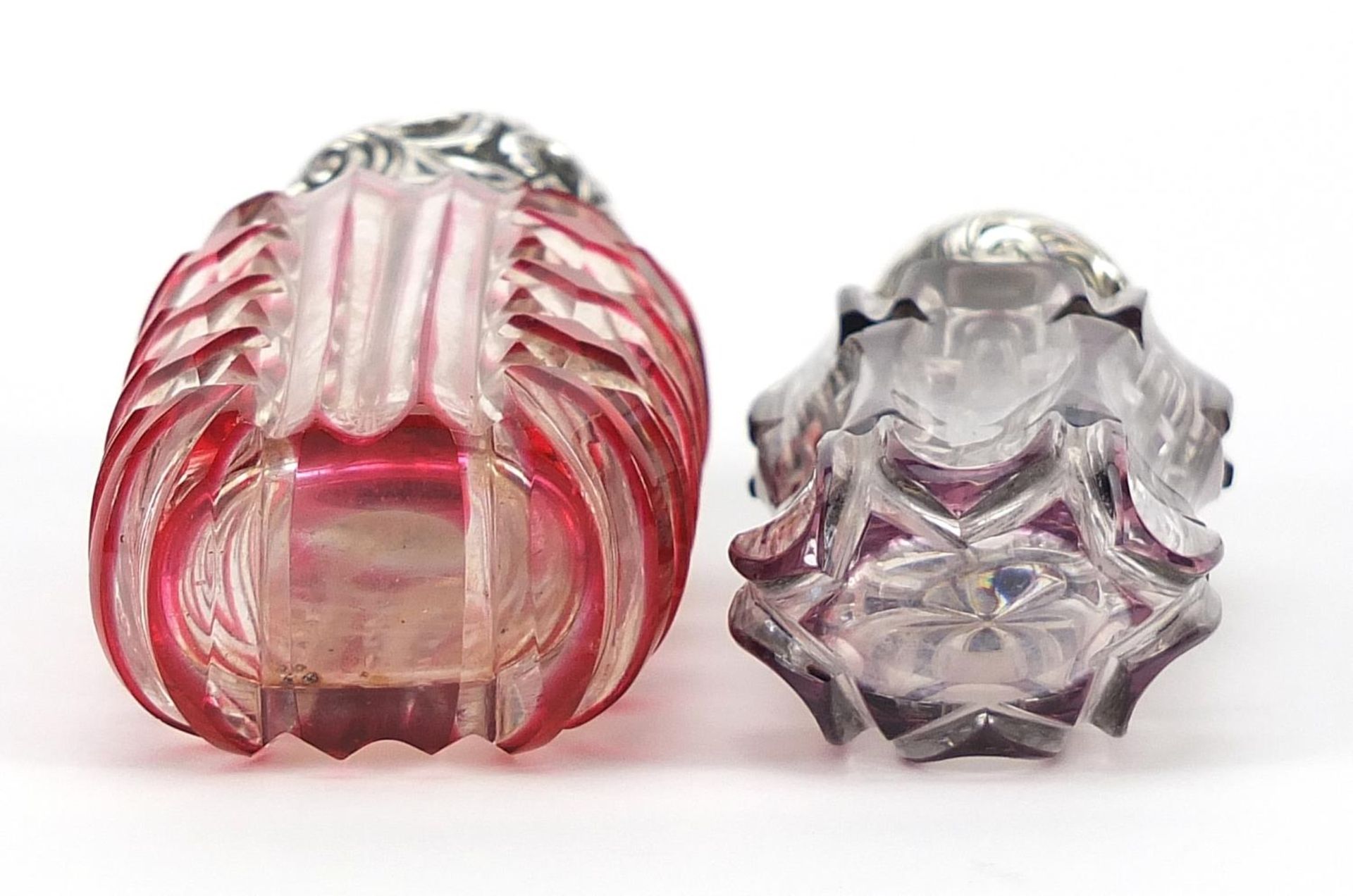Two Victorian cranberry and amethyst flashed cut glass scent bottles with silver lids, the largest - Image 3 of 3