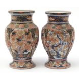 Matched pair of Japanese Imari porcelain vases hand painted and gilded with flowers, each 26cm high