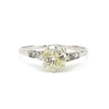 Platinum diamond solitaire ring with diamond set shoulders, the central diamond approximately 1.