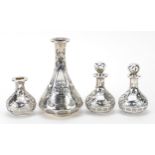 Four unmarked silver overlaid glass scent bottles including a pair with stoppers, the largest 13cm