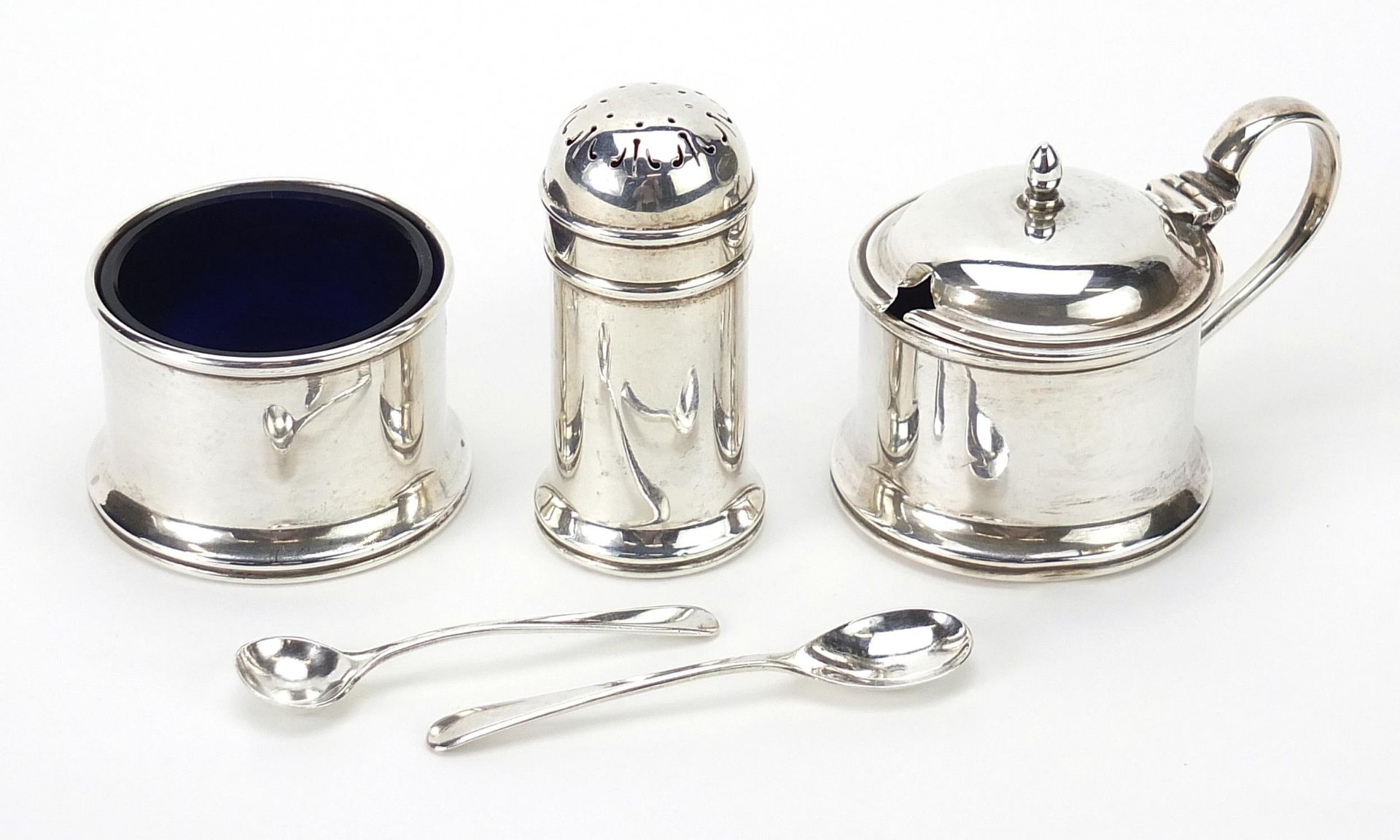 William Suckling Ltd, George V silver three piece cruet with blue glass liners, Birmingham 1932, the