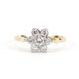 18ct gold diamond flower head ring, the central diamond approximately 0.2ct, size Q, 2.7g