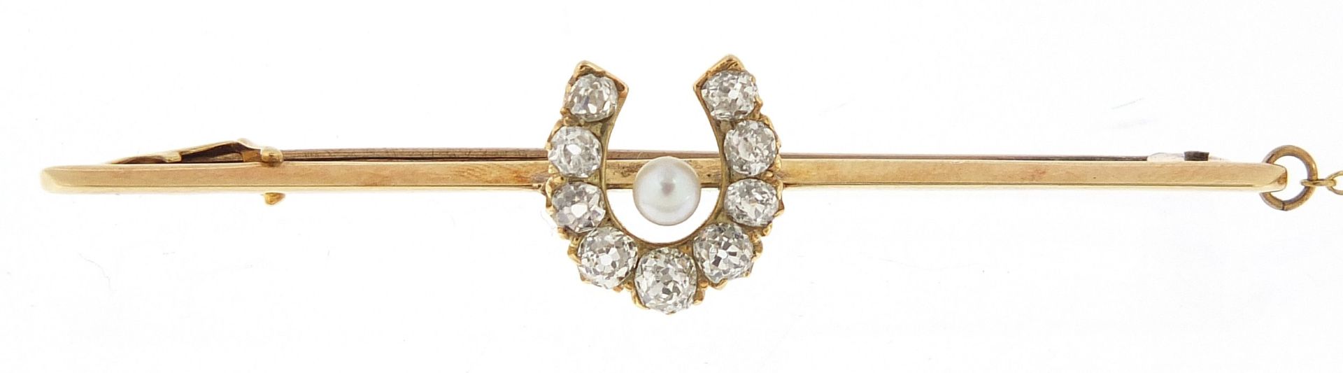 Unmarked gold diamond and pearl horseshoe bar brooch, the largest diamond approximately 0.11ct,