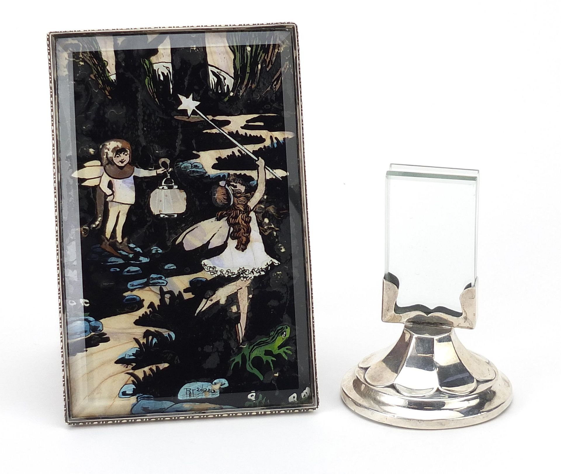 Rectangular silver framed butterfly wing picture of fairies and a circular silver desk photo