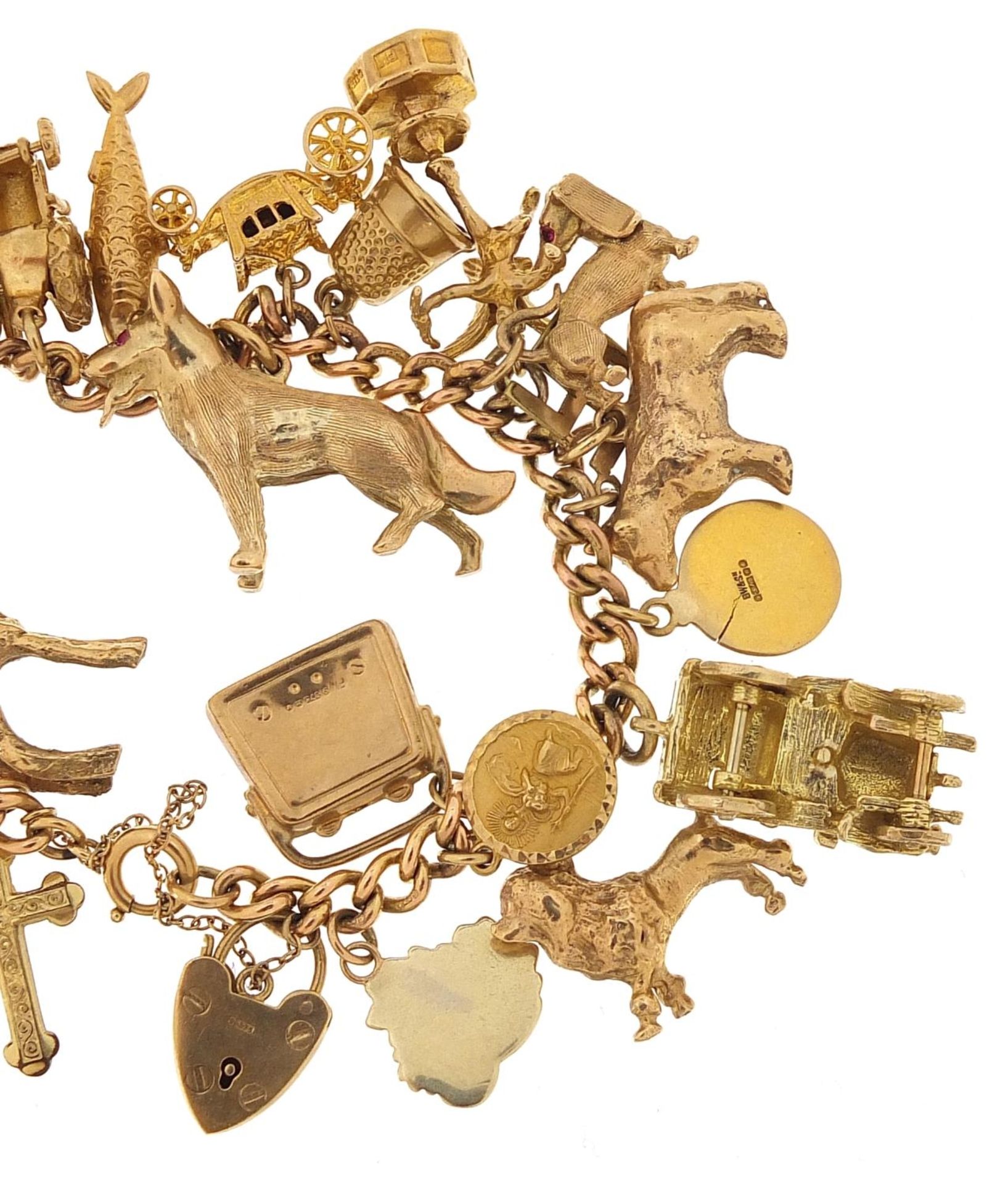 9ct gold charm bracelet with a large selection of mostly 9ct gold charms including Alsatian dog, - Image 6 of 7