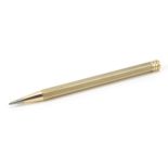 Unmarked gold propelling pencil with engine turned body, 11cm in length, 15.5g