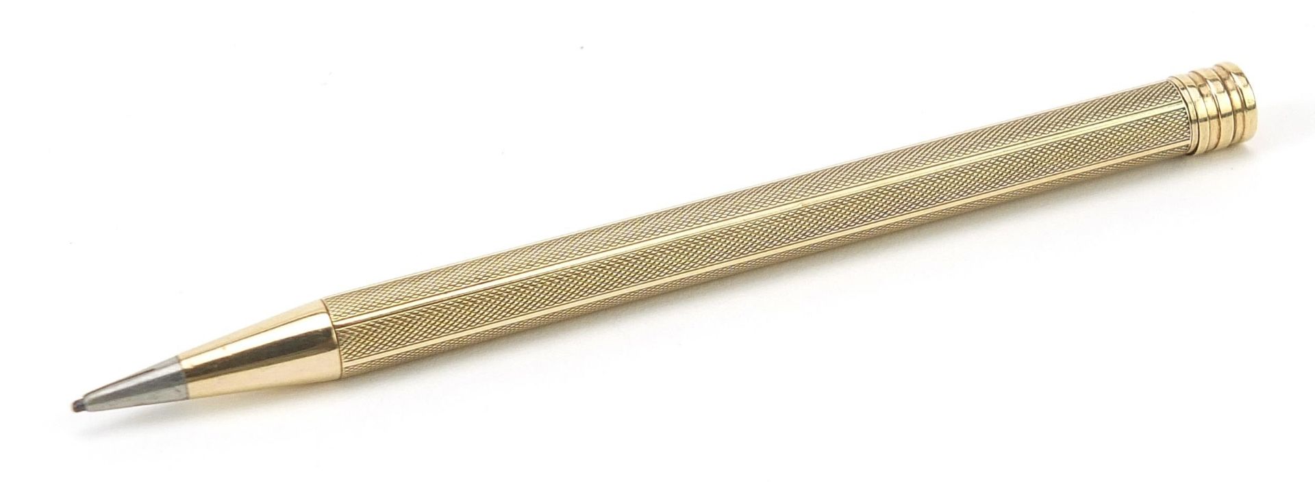 Unmarked gold propelling pencil with engine turned body, 11cm in length, 15.5g