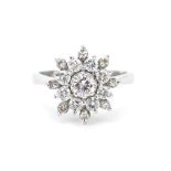 18ct white gold diamond three tier flower head ring, the central diamond approximately 0.25ct,