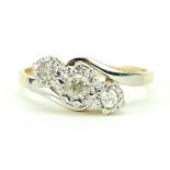 18ct gold and platinum diamond three stone crossover ring, size I, 2.4g