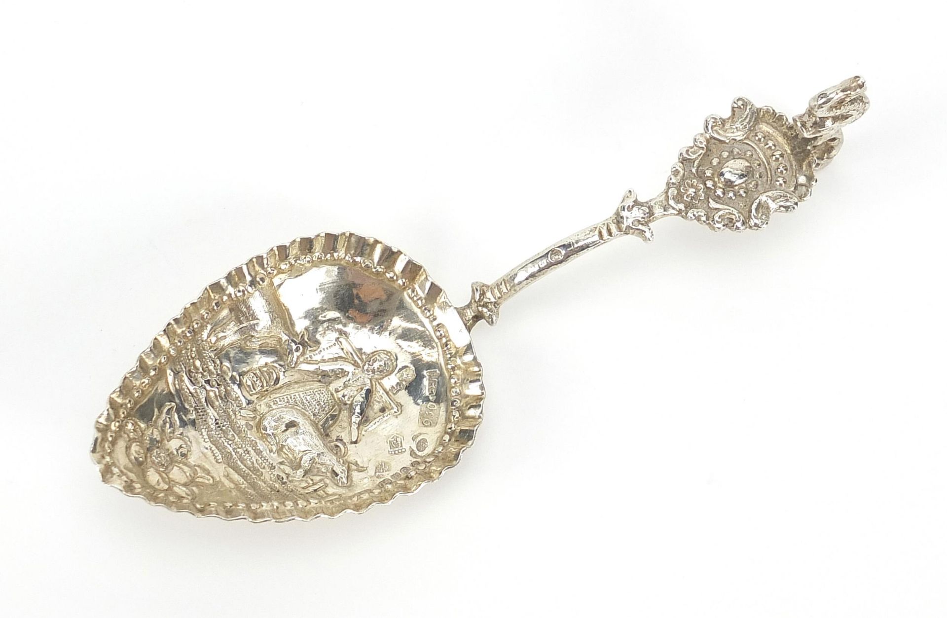 Antique Dutch silver caddy spoon, the bowl embossed with a lady farmer and cattle, indistinct