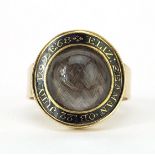 Georgian unmarked gold and black enamel mourning ring set with a central convex panel housing