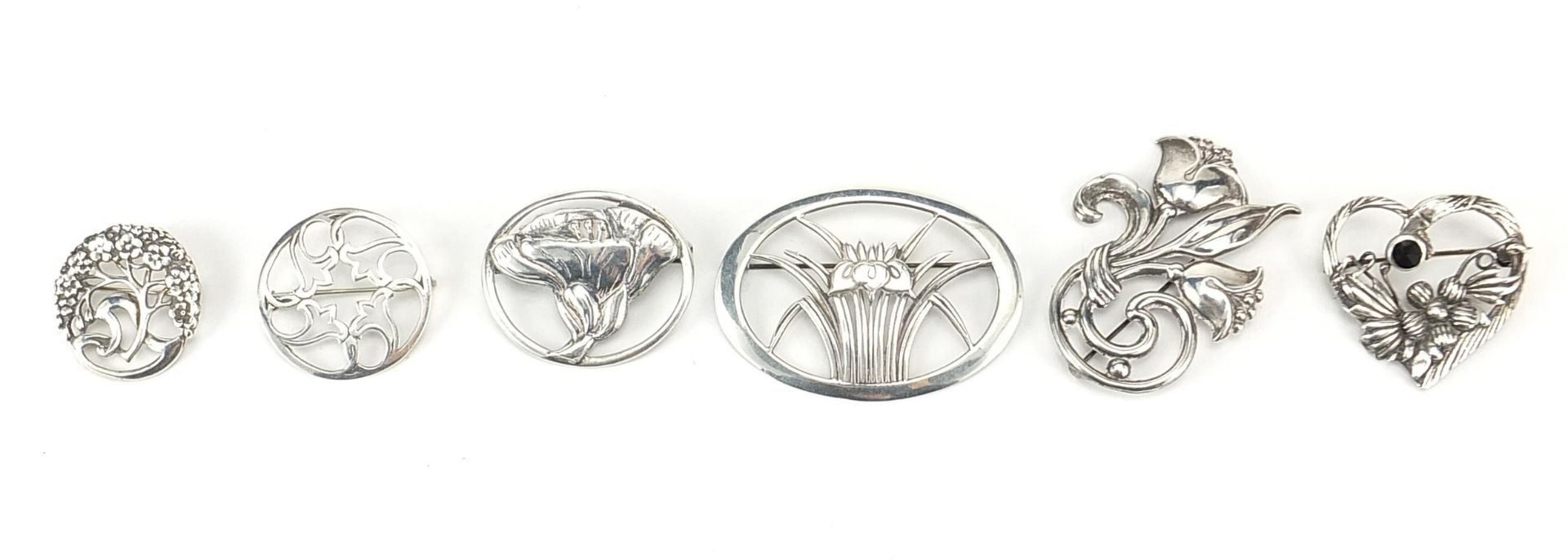 Six Art Nouveau design silver brooches, the largest 5.8cm wide, total 49.8g