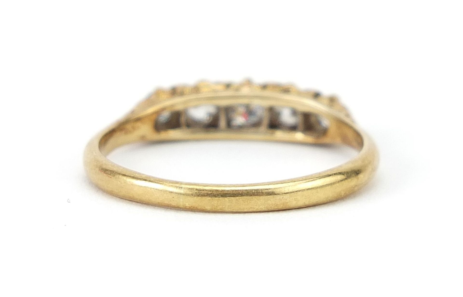 18ct gold graduated diamond five stone ring, the central diamond approximately 0.15ct, size R/S, 3. - Image 3 of 5