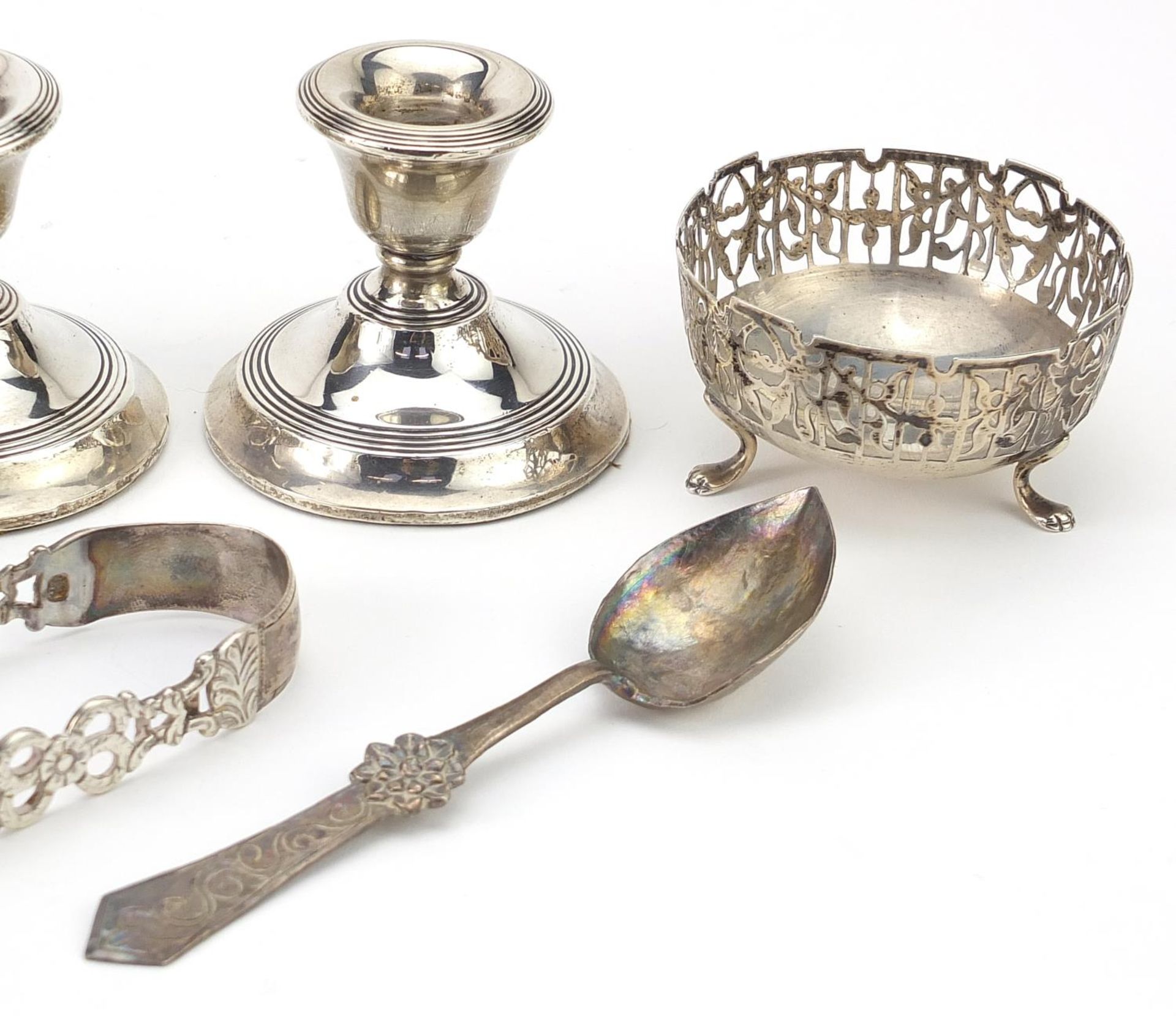 Silver objects comprising pair of dwarf candlesticks, pair of open salts, sugar tongs and a spoon, - Image 3 of 5