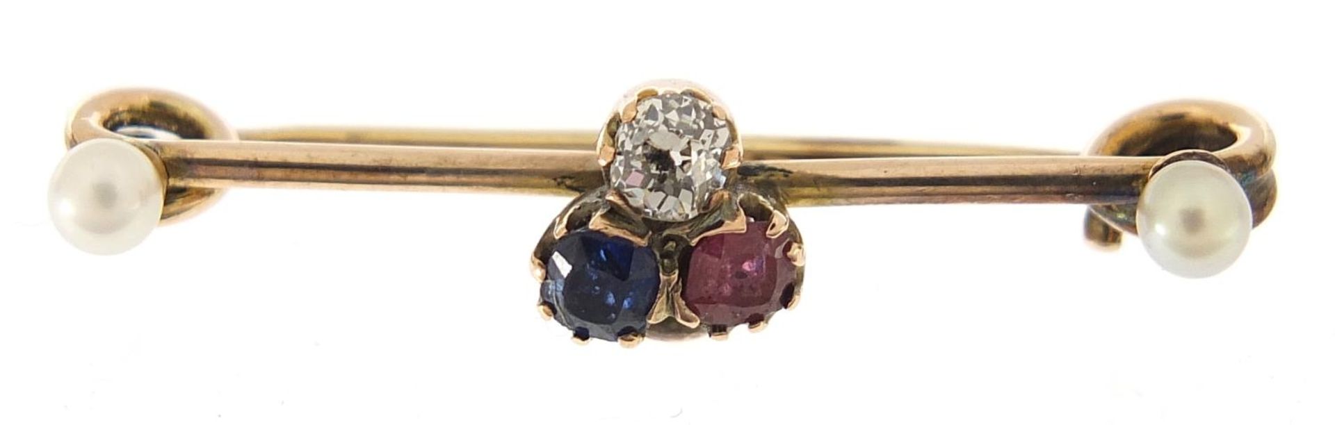Unmarked gold diamond, sapphire, ruby and pearl brooch, the diamond approximately 3mm in diameter,
