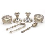 Silver objects comprising pair of dwarf candlesticks, pair of open salts, sugar tongs and a spoon,