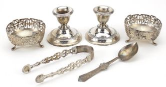 Silver objects comprising pair of dwarf candlesticks, pair of open salts, sugar tongs and a spoon,