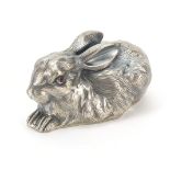 Silver recumbent rabbit paperweight with ruby eyes, impressed Russian marks to the base, 6.5cm in