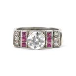Art Deco unmarked white metal diamond solitaire ring with ruby and diamond shoulders, the central