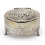 Circular unmarked silver jewel box with hinged filigree lid and mirrored interior raised on three