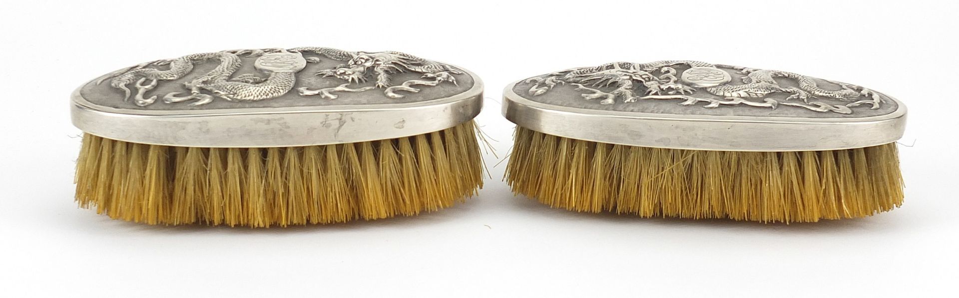 Pair of Chinese silver backed brushes embossed with dragons by Woshing, 13cm wide - Image 2 of 5