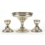 Silver pedestal dish and a pair of circular silver dwarf candlesticks, the pedestal dish 9.5cm