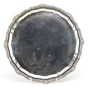 Garrard & Co Ltd, circular silver salver with Celtic design border and raised on three feet,
