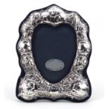 Art Nouveau design silver easel photo frame embossed with Putti and stylised flowers, R.B.B,