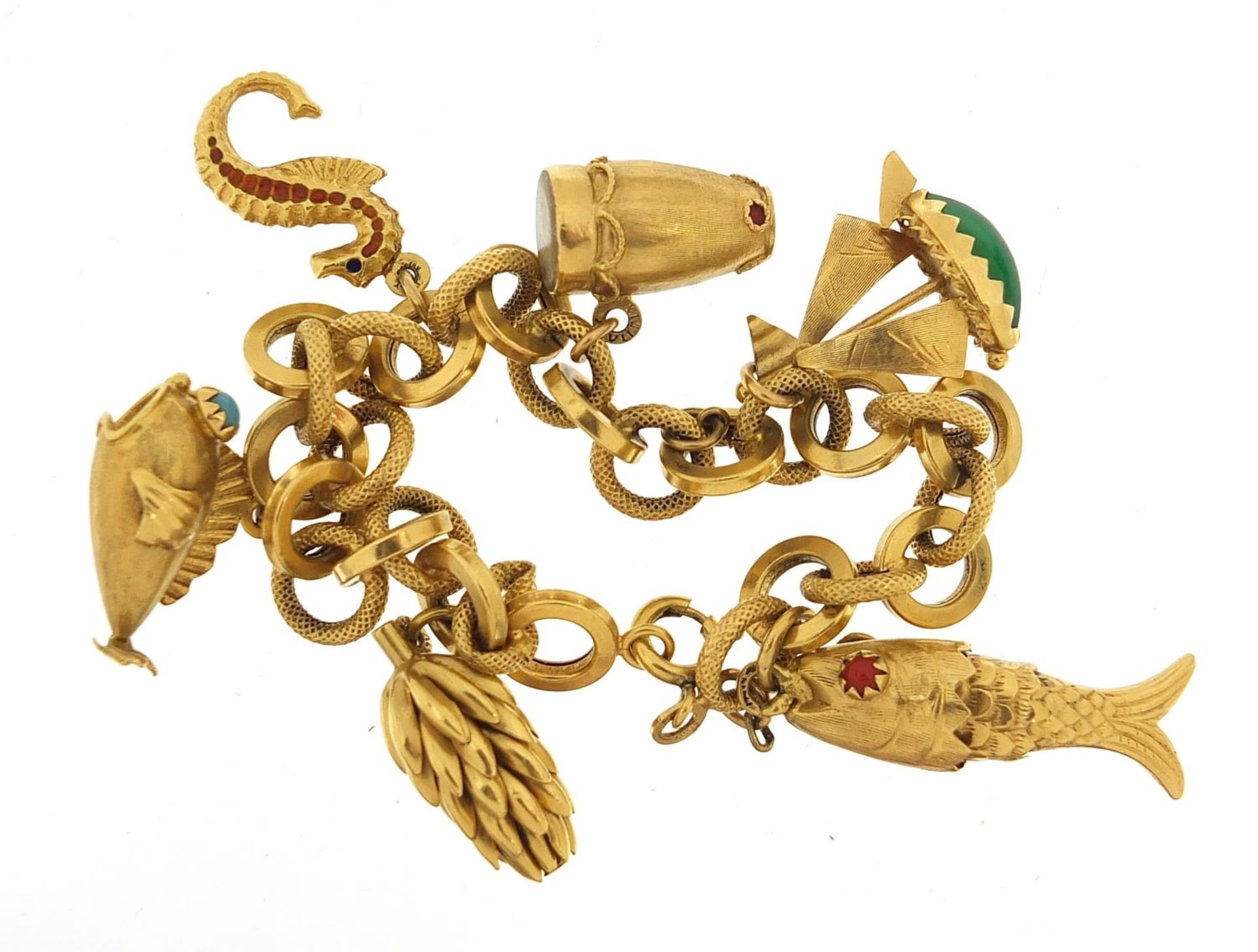 18ct gold charm bracelet with a selection of gold charms including enamelled seahorse, drum with