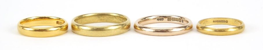 Four gold rings comprising one 22ct gold, size K, 4.0g, two 18ct gold, sizes J and Q, 7.6g and one