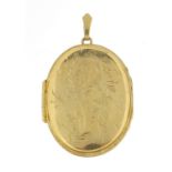Large 9ct gold oval locket engraved with flowers, 4.2cm high, 12.2g - this lot is sold without