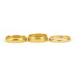 Three 22ct gold wedding bands, sizes L and O, 10.9g - this lot is sold without buyer?s premium,