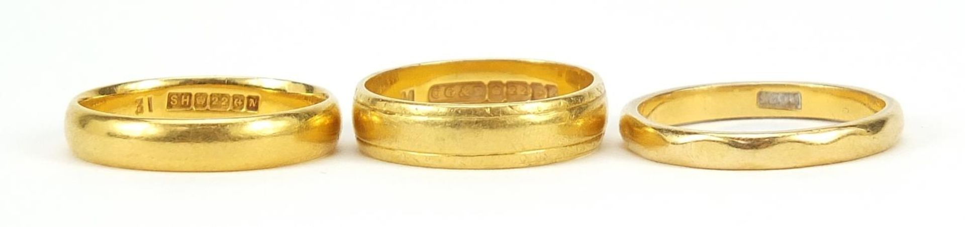 Three 22ct gold wedding bands, sizes L and O, 10.9g - this lot is sold without buyer?s premium,