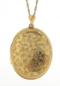 Oval 9ct cold locket engraved with flowers on a 9ct gold rope twist necklace, 3.4cm high and 62cm in