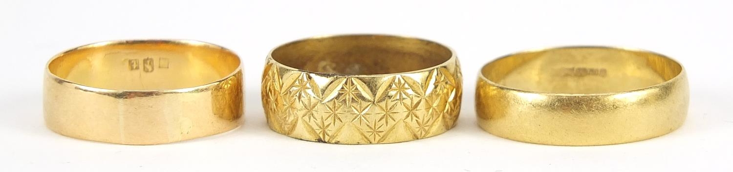 Gold rings comprising two 18ct gold, size O and T, 9.0g and one other with indistinct marks, size R,