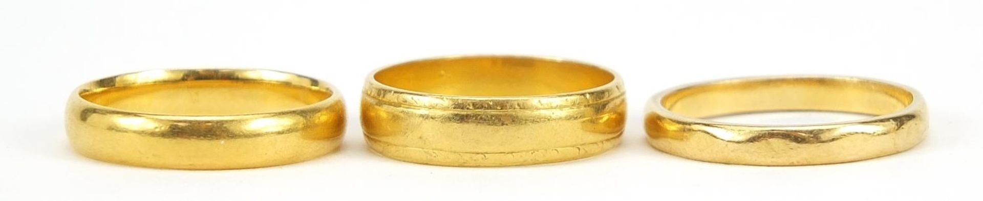 Three 22ct gold wedding bands, sizes L and O, 10.9g - this lot is sold without buyer?s premium, - Image 3 of 7