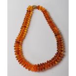VINTAGE 20TH CENTURY AMBER AND GOLD PEBBLE GRADUATED BEADED NECKLACES