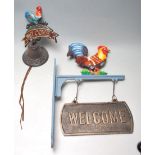 TWO VINTAGE CAST IRON POLYCHROME WELCOME SIGNS