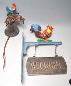 TWO VINTAGE CAST IRON POLYCHROME WELCOME SIGNS