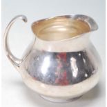 A 1960'S ERIC CLEMENTS FOR MAPPIN & WEBB SILVER PLATED CREAMER JUG