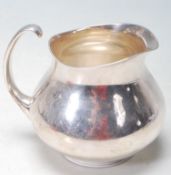A 1960'S ERIC CLEMENTS FOR MAPPIN & WEBB SILVER PLATED CREAMER JUG