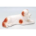 SITZENDORD CERAMIC FIGURINE OF A DOG RECLINING