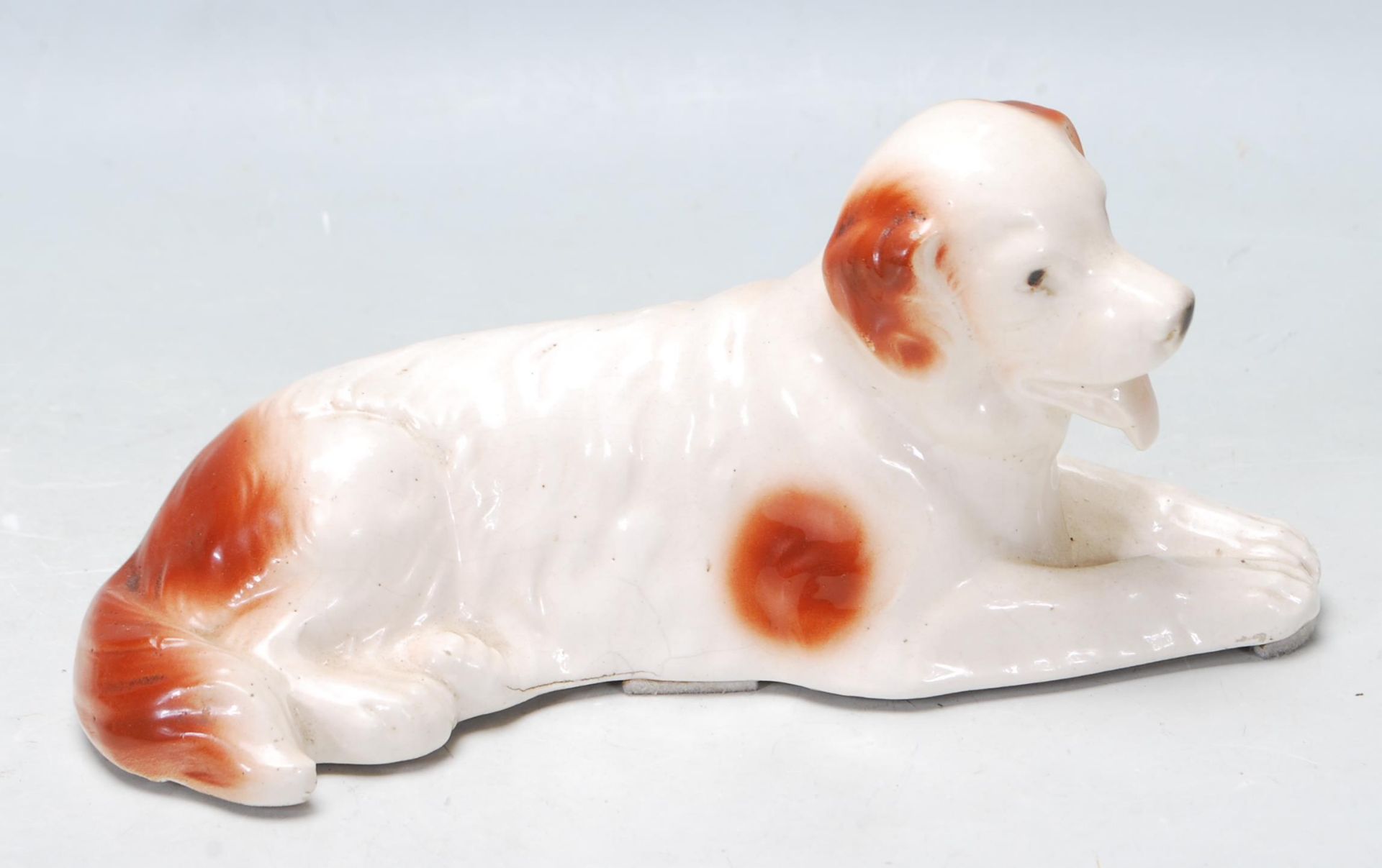 SITZENDORD CERAMIC FIGURINE OF A DOG RECLINING