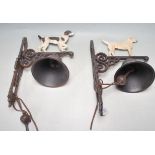TWO VINTAGE STYLE CAST IRON BELLS WITH DOGS IN PROFILE TO THE TOP