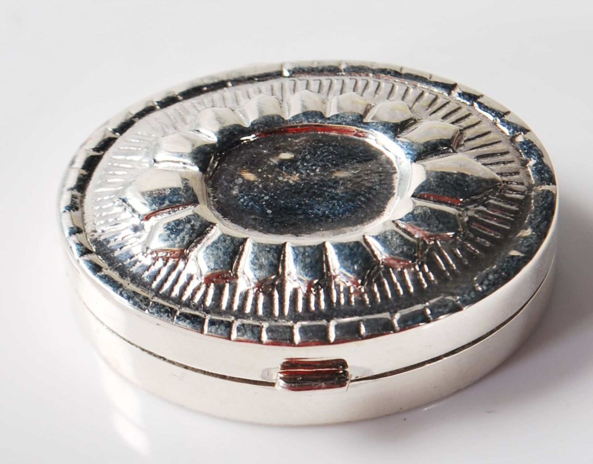 SILVER PILL BOX WITH REPOUSSE DECORATION TO THE LID