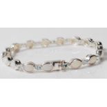 CONTEMPORARY SILVER OPAL AND BLUE STONE TENNIS BRACELET