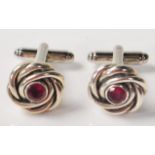 PAIR OF SILVER KNOT DESIGN CUFFLINKS WITH RED STONES