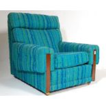 A retro mid century teak wood and upholstered easy chair / armchair
